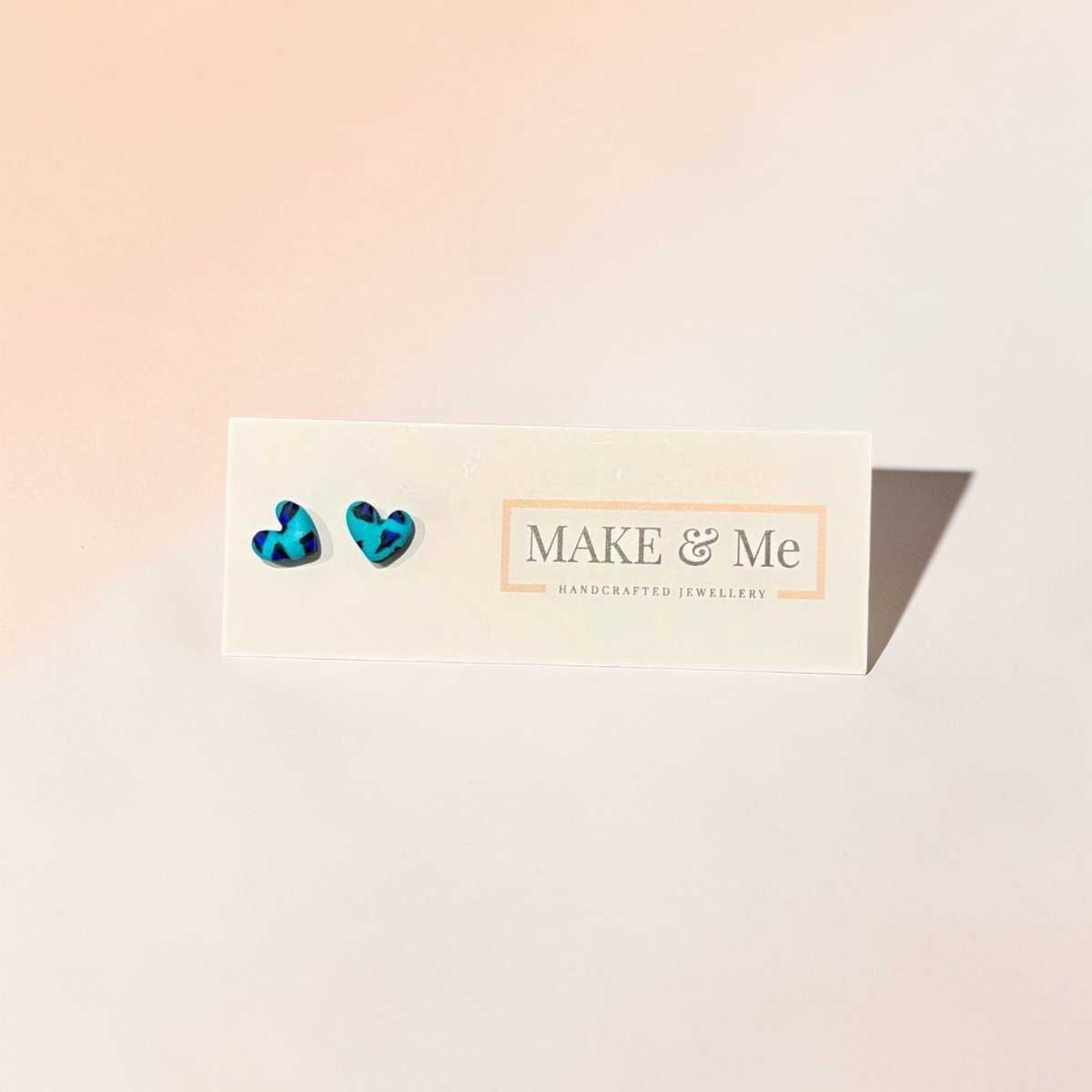 Turquoise heart-shaped earrings on a &