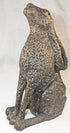 A textured bronze-finished sculpture of a sitting hare, shown against a plain white background.