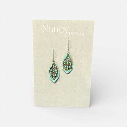 Teardrop-shaped earrings on a Nancy Jones card against a white background