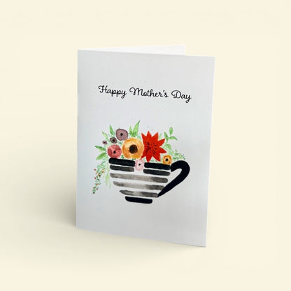 Greeting card with a teacup and flowers design, featuring &