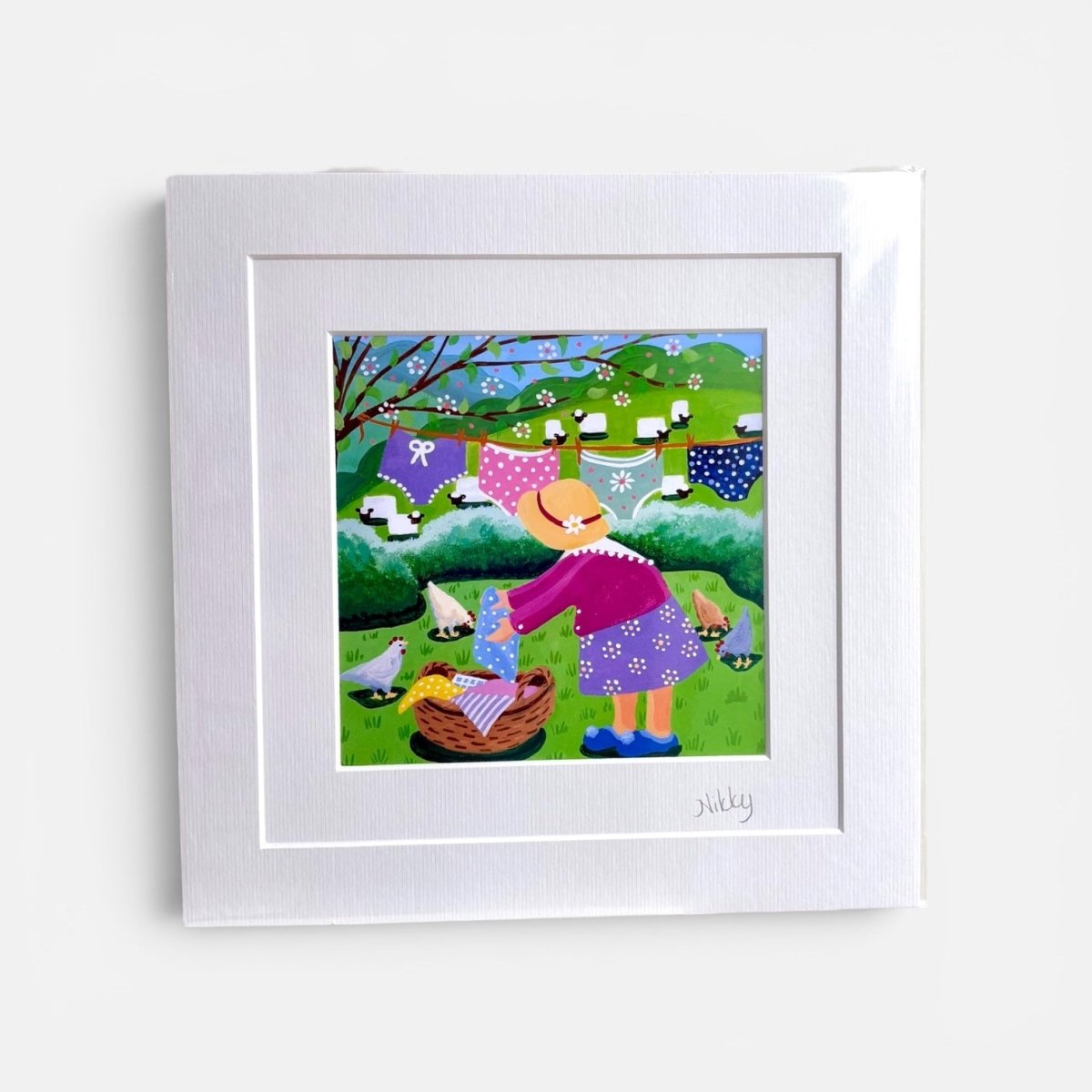 Framed artwork of a cartoon character with laundry on a line against a white background