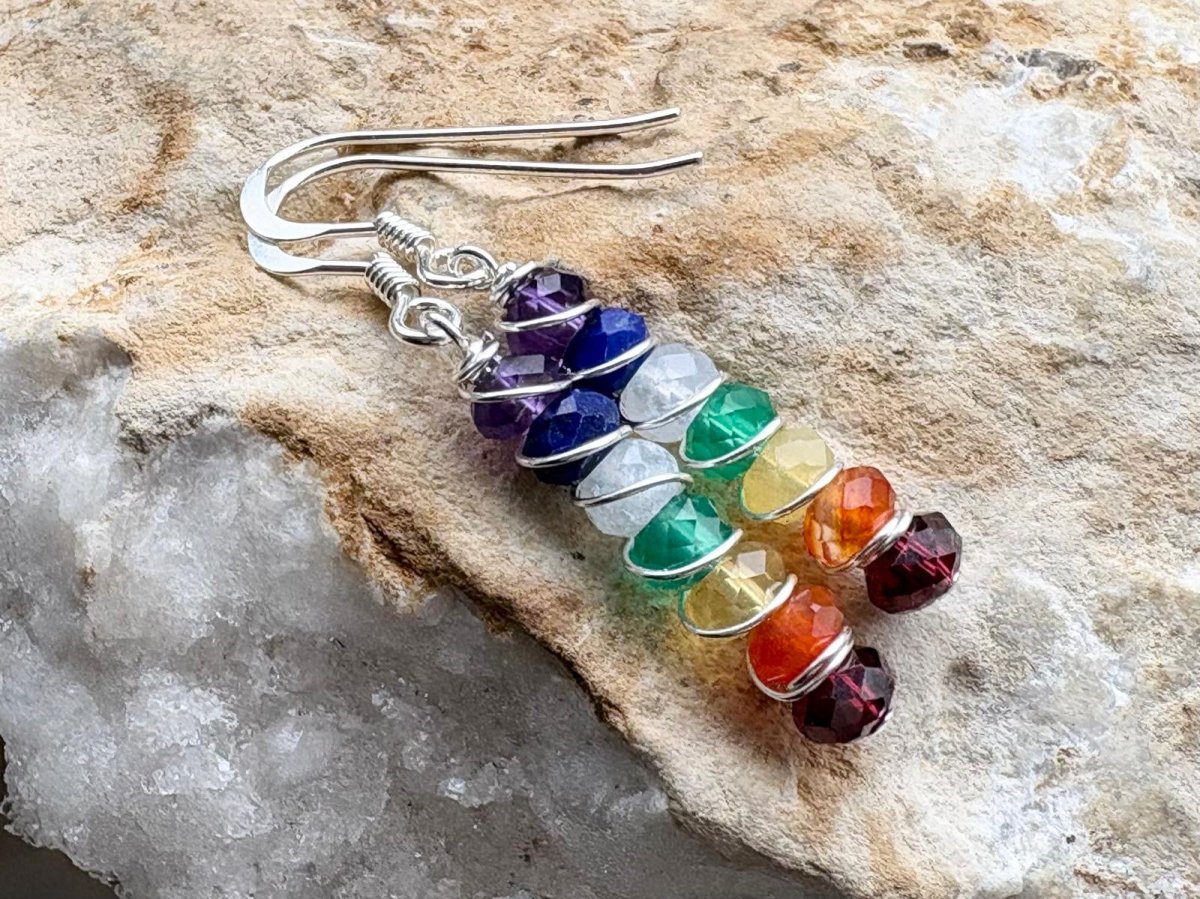 Colorful beaded earrings on a stone surface