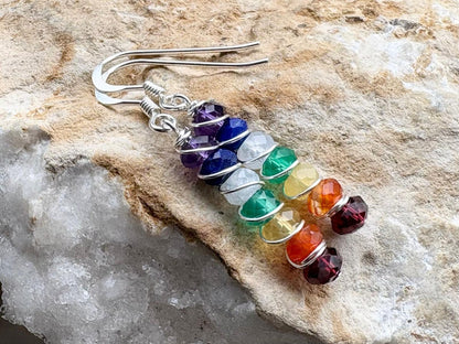 Colorful beaded earrings on a stone surface