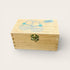 Wooden box with baby shoes design on a light background