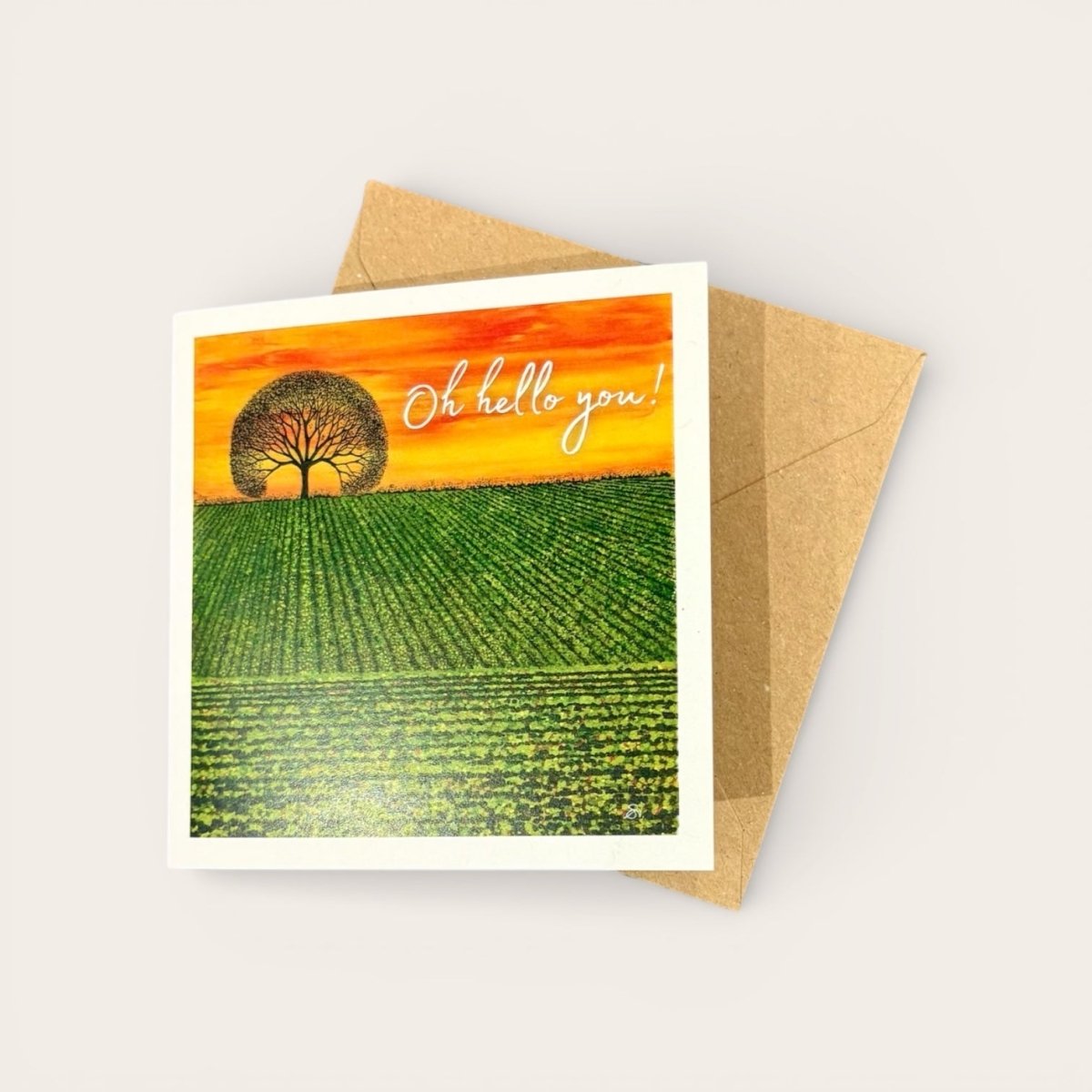 Greeting card with a field and tree design and &
