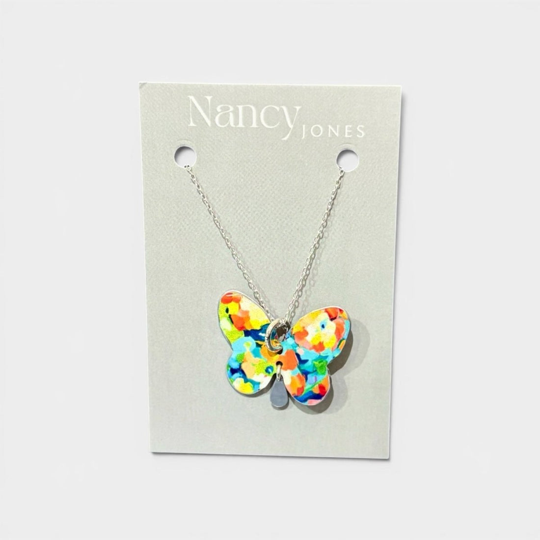 Colorful butterfly necklace on a Nancy Jones card