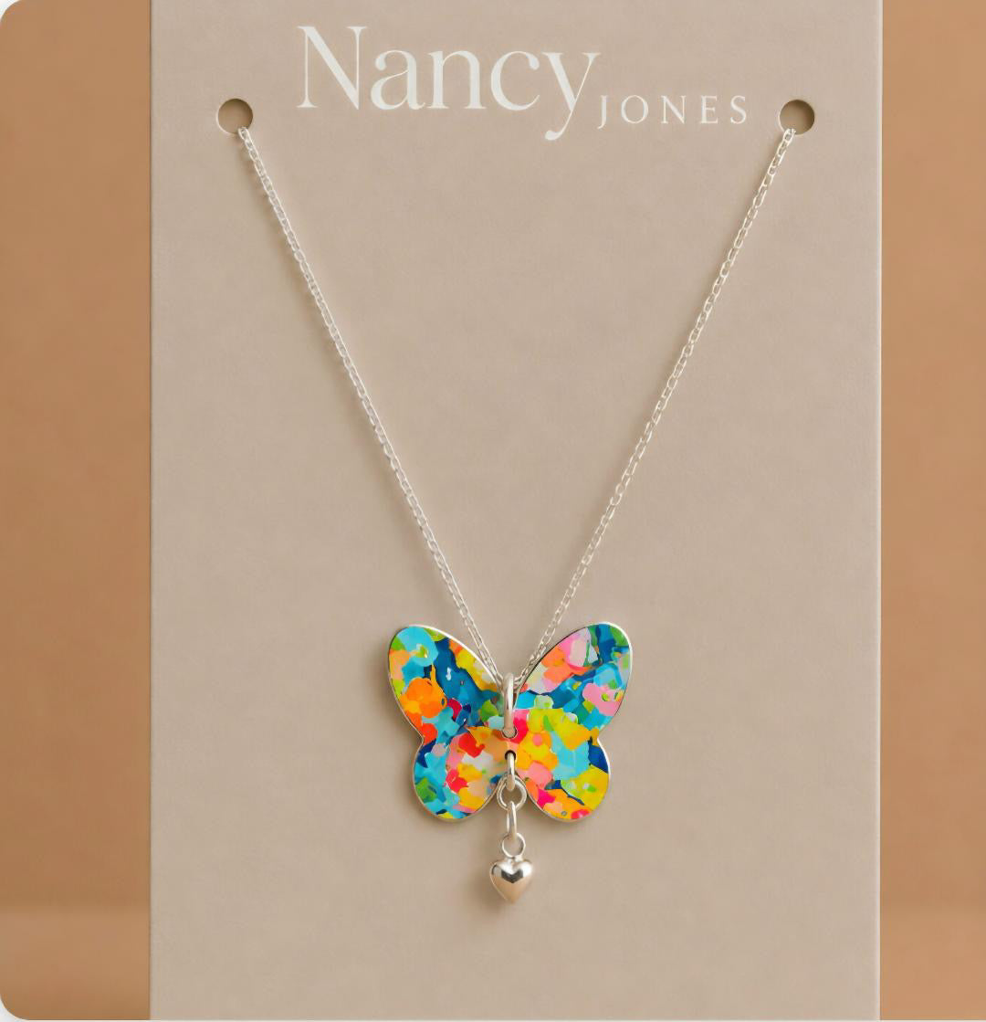 Colorful butterfly necklace on a Nancy Jones card