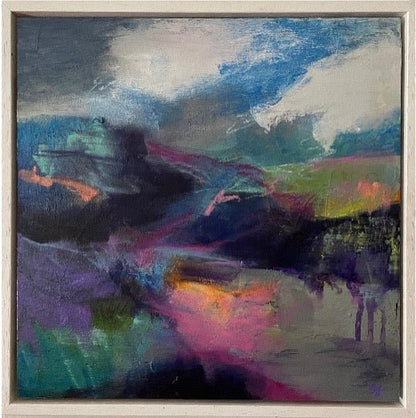 An abstract landscape painting featuring a dramatic sky with blue, white, and gray clouds, and a dark, shadowy mountain range with vibrant purple, pink, green, and orange brushstrokes below, housed in a light-colored wooden frame.