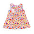 A sleeveless baby dress with a colorful sailboat print on a light pink background, featuring a ruffled neckline and a white hangtag.