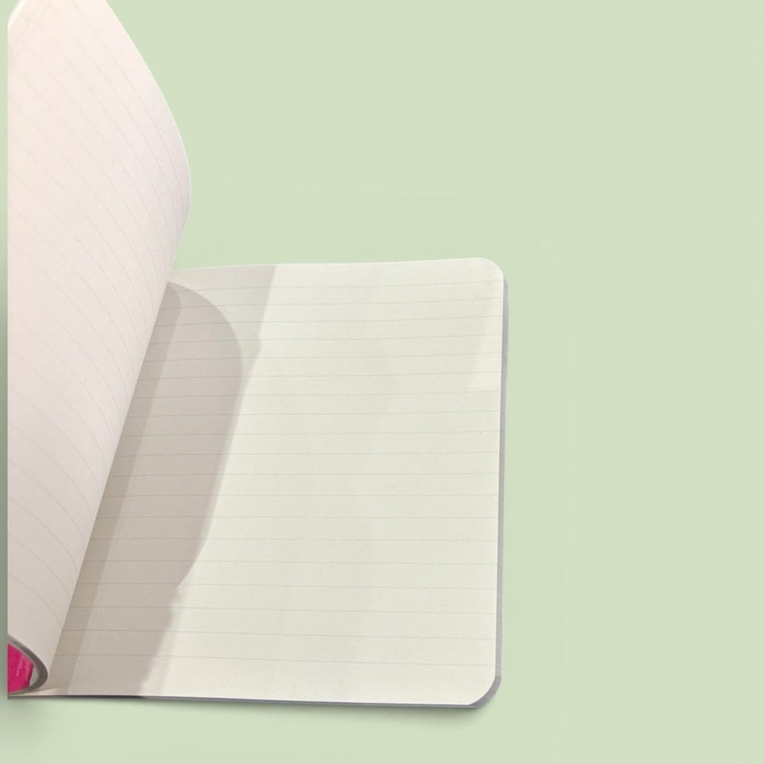 Open notebook with lined pages on a light green background