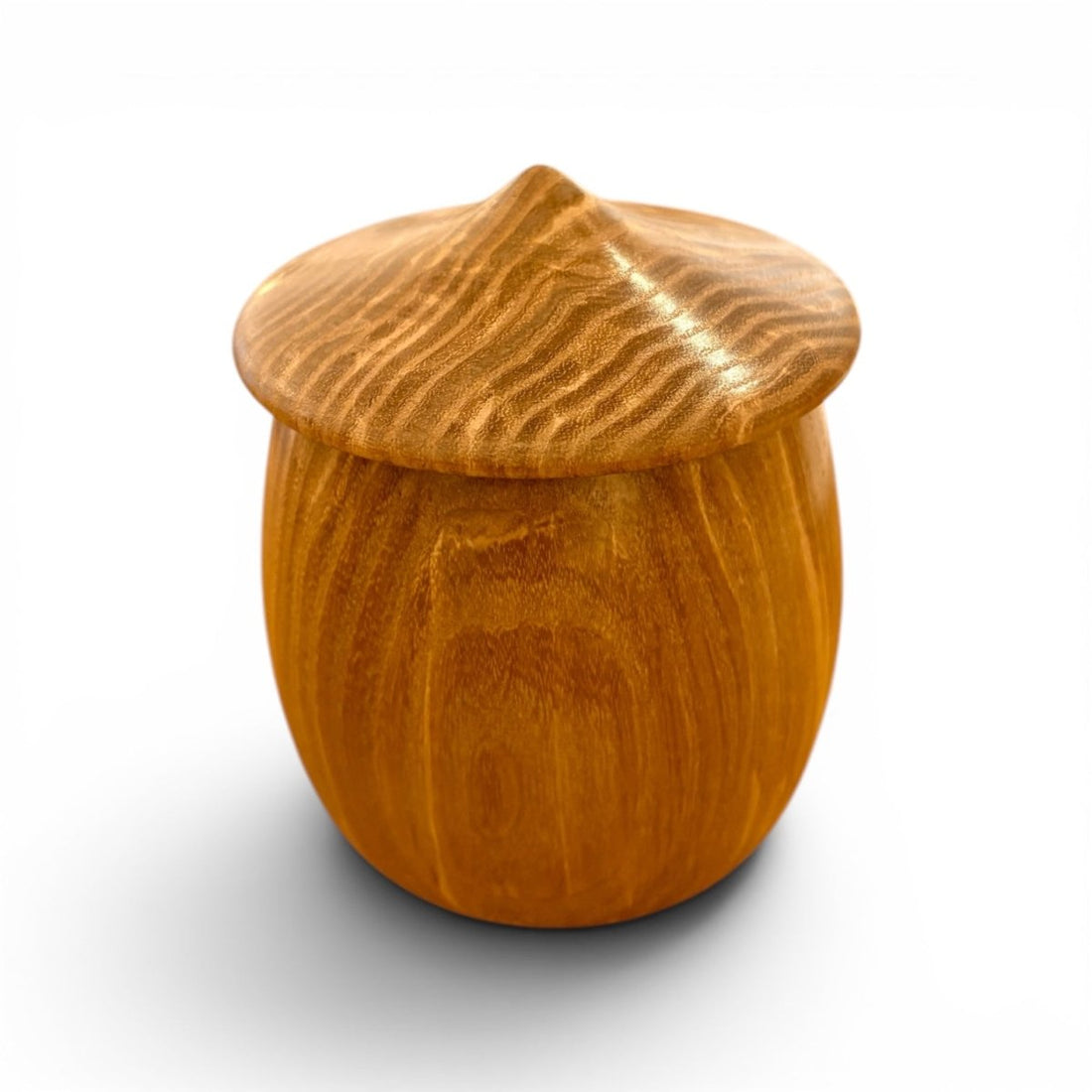 A small rounded wooden keepsake box with a matching lid, featuring a warm honey-brown wood grain finish, shown on a white background with a soft shadow.