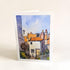 Greeting card with a painting of a quaint village scene on a white background