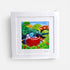 Framed artwork of two dogs in a red rowboat with a bridge and trees in the background.