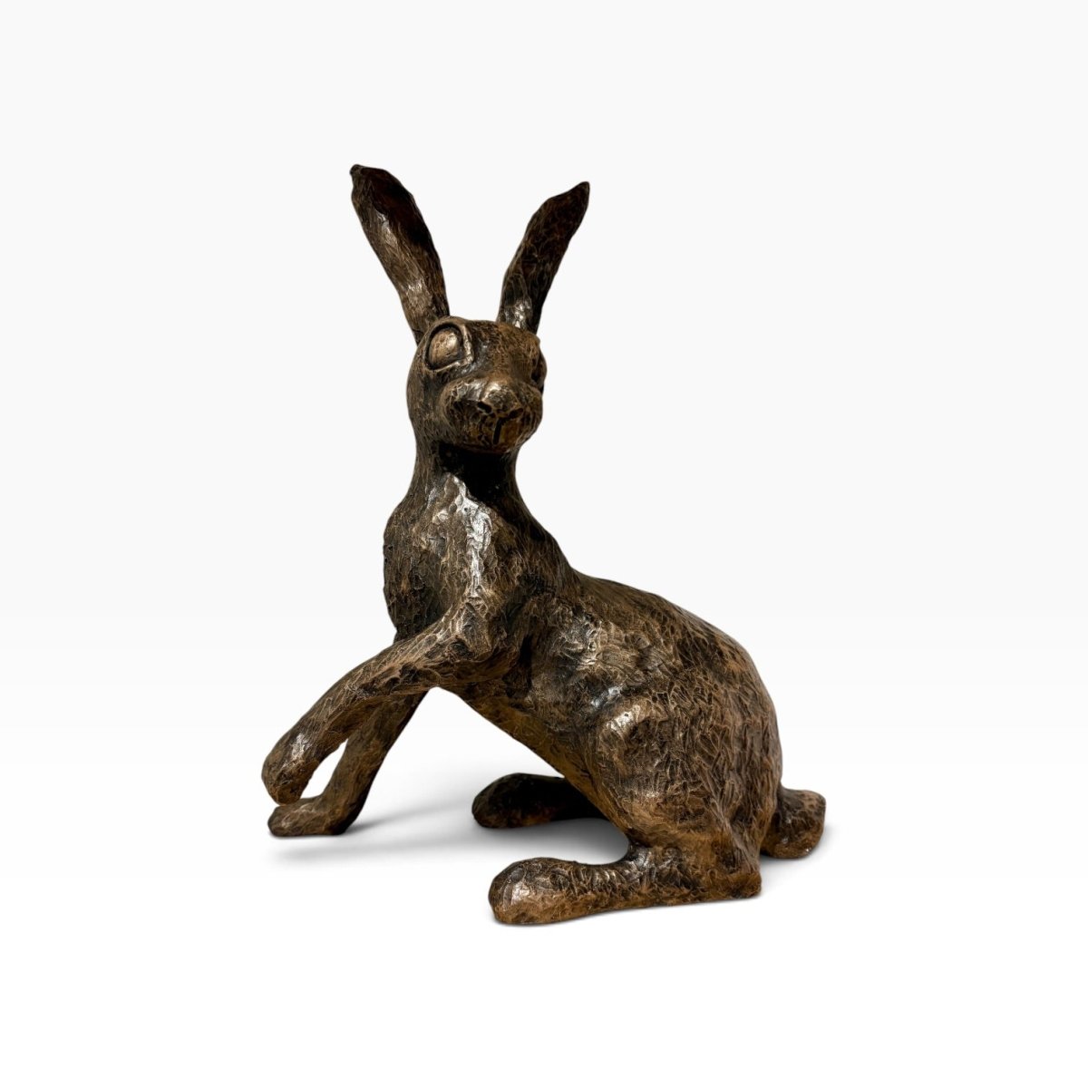A bronze-finished sculpture of a sitting hare, shown on a clean white background.