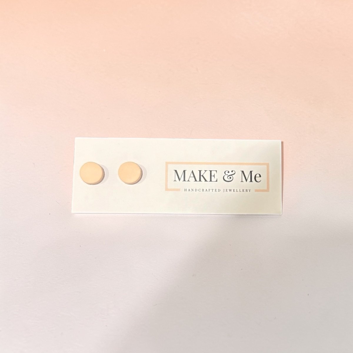 Make &amp; Me earrings on a soft pink background