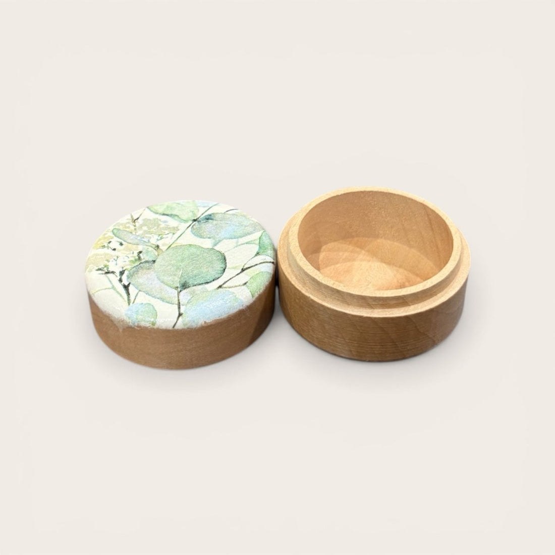 Wooden box with a floral lid on a light background