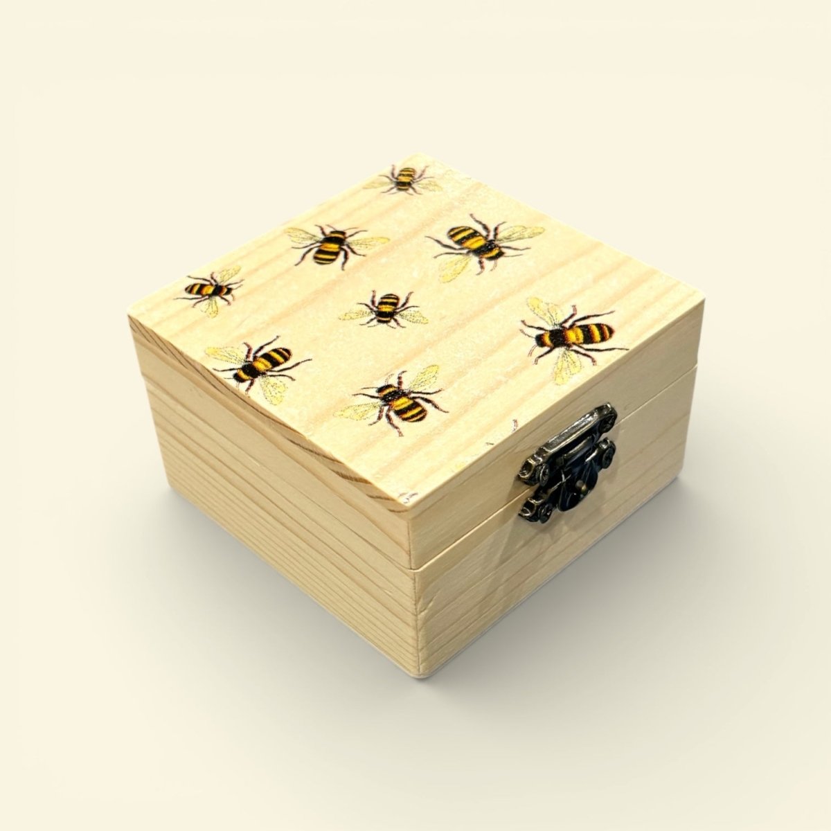 Wooden box with bee patterns on a beige background