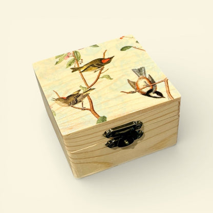 Wooden box with bird design on lid against a beige background