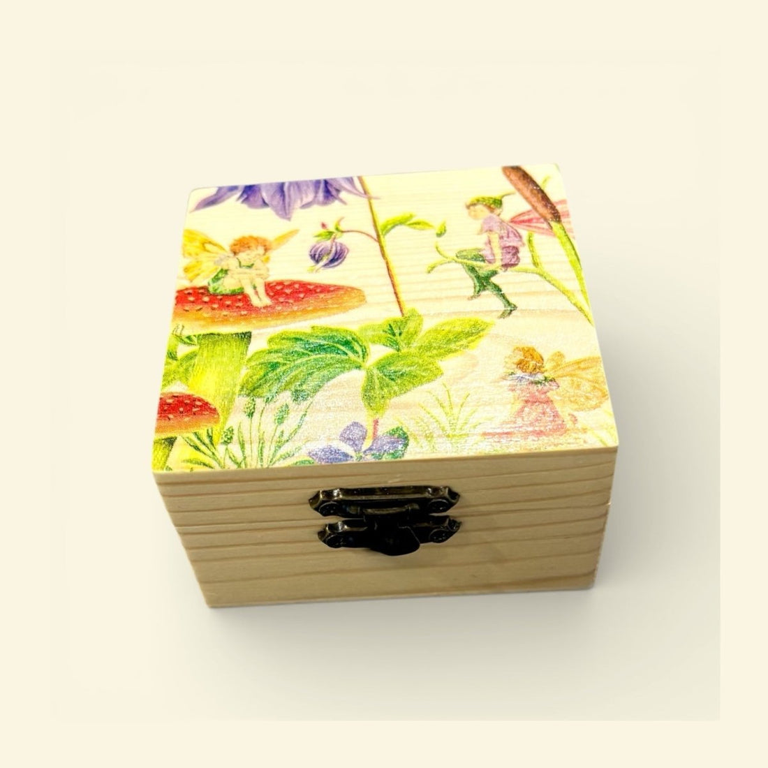 Wooden box with colorful fairy design on a white background