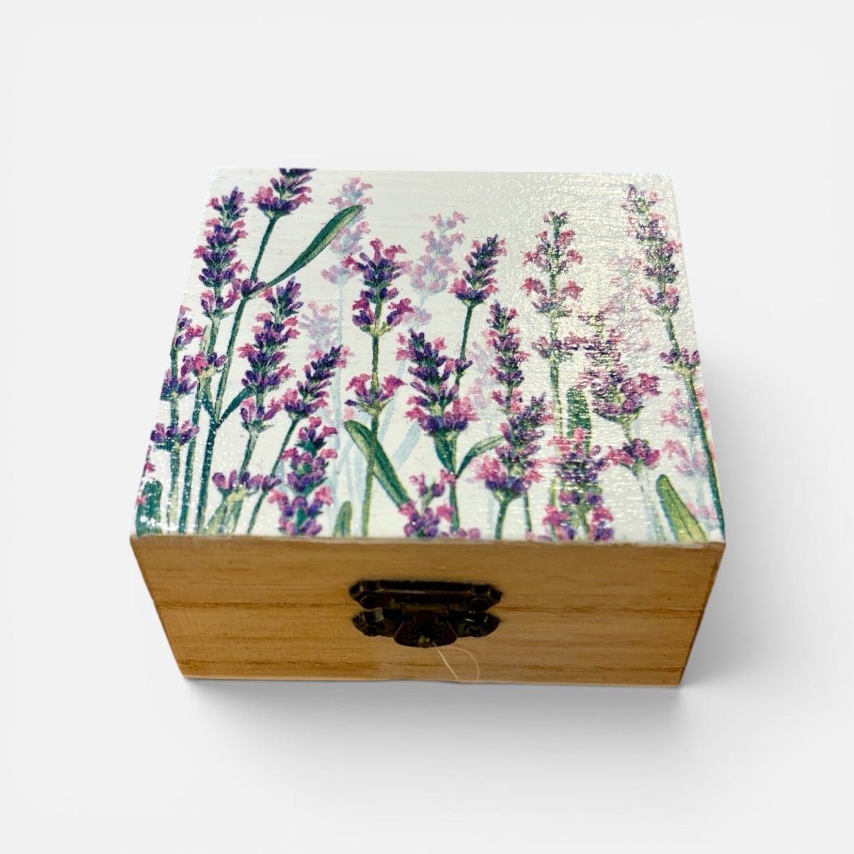 A square wooden keepsake box with a floral lavender painting on the lid, featuring a black metal clasp on the front, set against a plain white background.