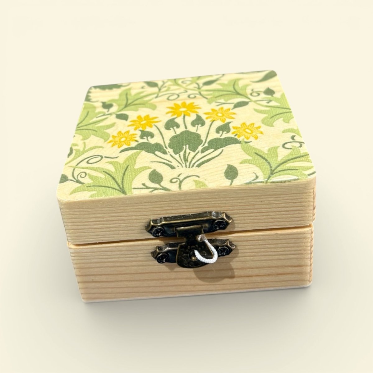Wooden box with floral pattern on a beige background