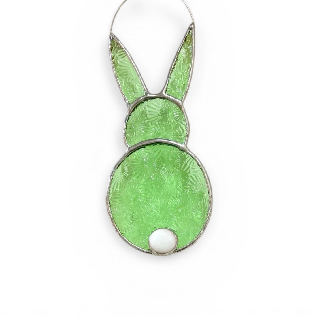 Stained glass bunny shaped decoration with green and white colors on a white background