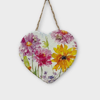 Heart-shaped wooden plaque with floral design hanging on a white background