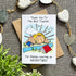 Card with teacher appreciation message and illustrations on a textured surface with decorative elements.