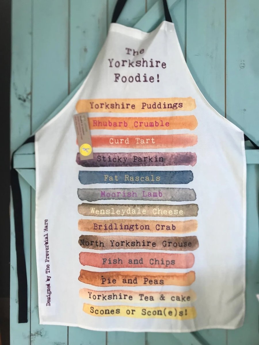 Apron with Yorkshire food items listed on a wooden background