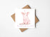 Greeting card with a pig illustration and text, accompanied by a brown envelope on a white background.