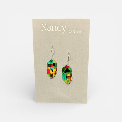Colorful geometric earrings on a Nancy Jones branded card.