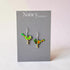 Bird-shaped earrings on a Nancy Jones card with a light pink background