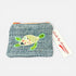 Textured pouch with a turtle design and a tag reading &