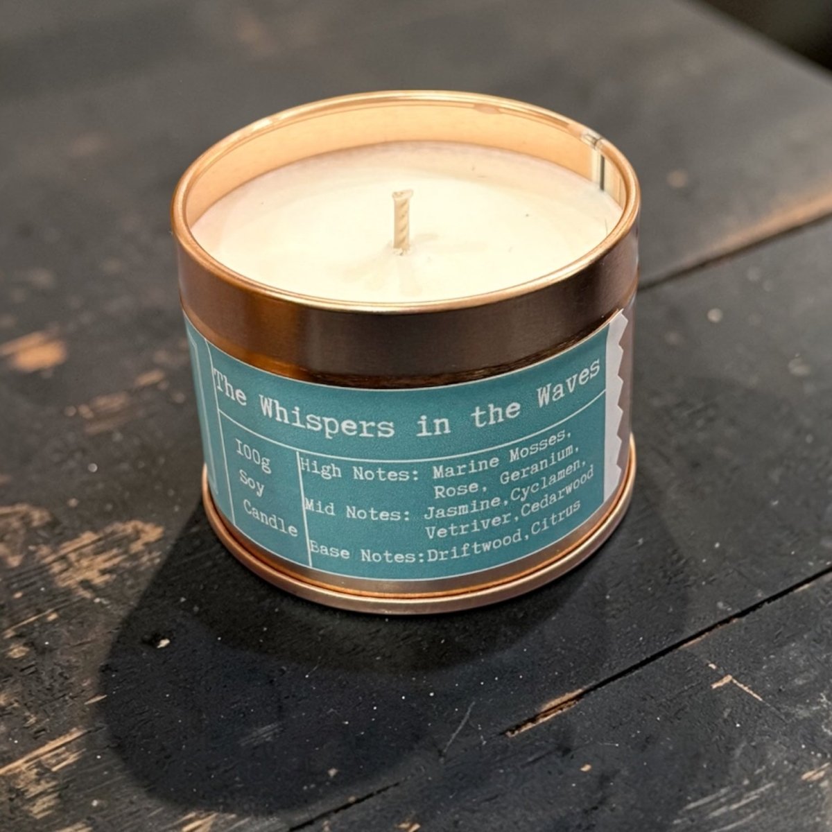 Candle in a tin labeled &