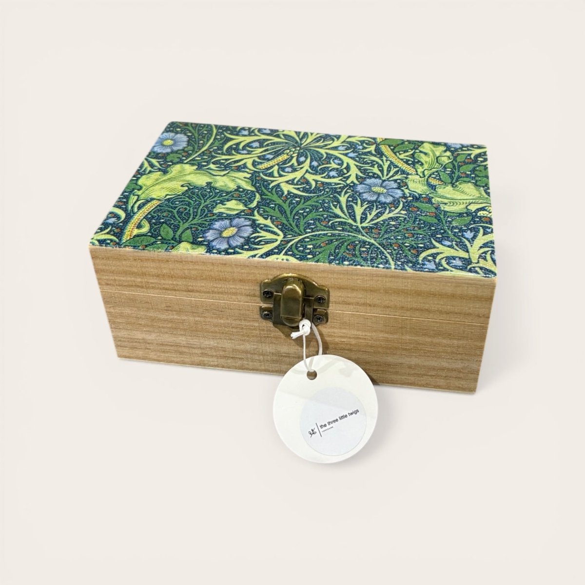 Wooden box with floral patterned lid on a white background