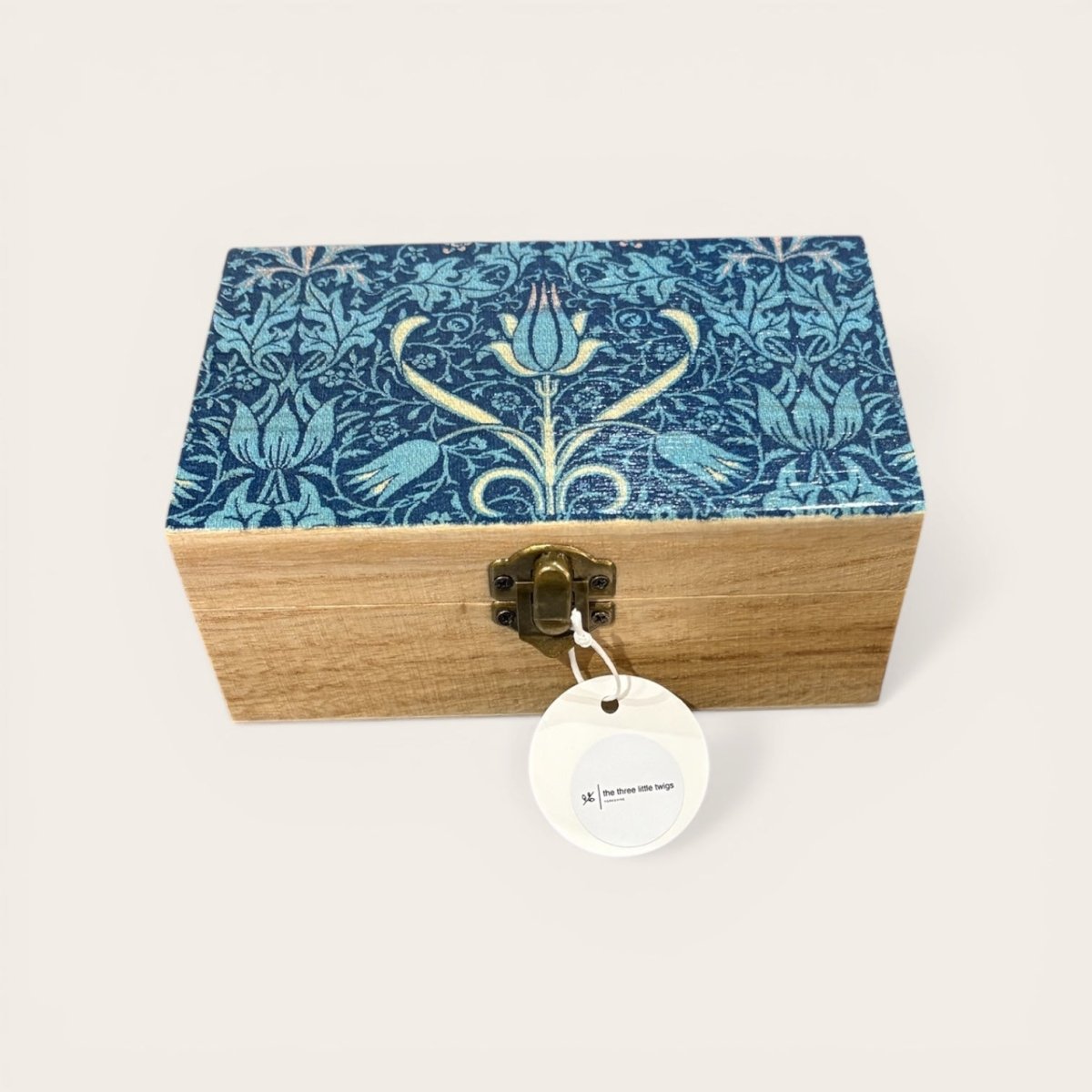 Wooden box with floral patterned lid on a white background