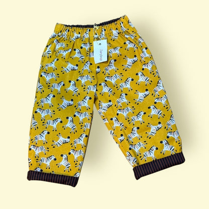 Yellow trousers with zebra pattern on a beige background