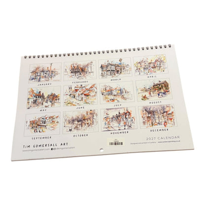 A spiral-bound 2027 wall calendar from Tim Comersall Art, displayed at an angle on a clean white background. The cover features twelve square watercolor illustrations of street scenes, each labeled with its respective month.