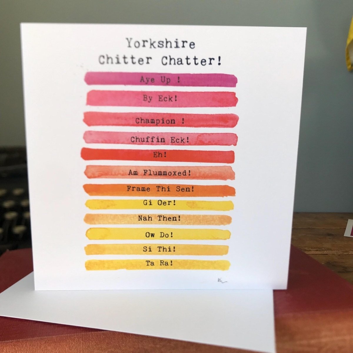 Card with Yorkshire dialect phrases in a colorful gradient on a white background