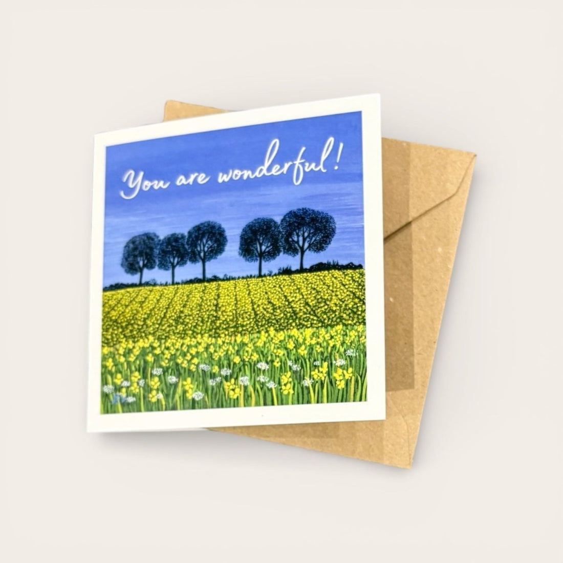 Greeting card with a field of flowers and trees, and &